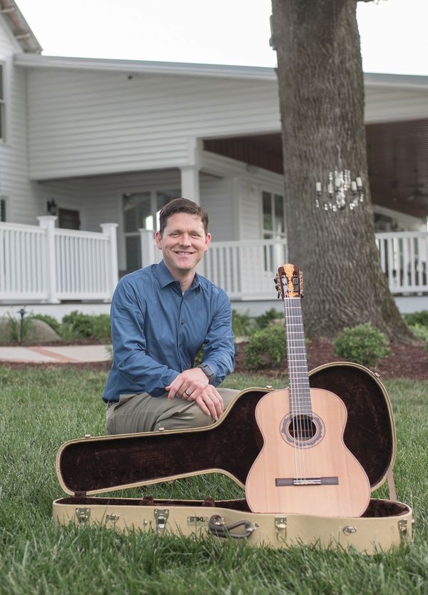 Aaron Prillaman posing with his guitar at Triple J Manor House.