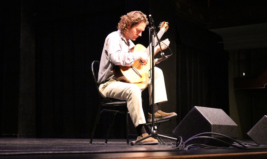 Aaron Prillaman playing classical guitar at the McGlohon Theater in Charlotte, NC.
