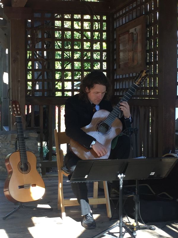 Aaron Prillaman playing classical guitar at the North Carolina Arboretum.