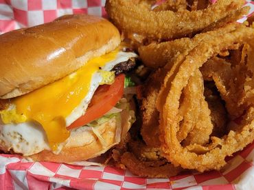 Ruby Red Sunrise: ¼ lb burger topped with fried egg, bacon, cheddar cheese, mayo, lettuce and tomato
