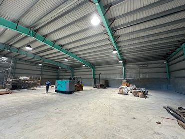 Completed construction site with workers performing final inspections