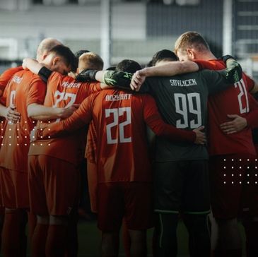 Football team huddling before the game.