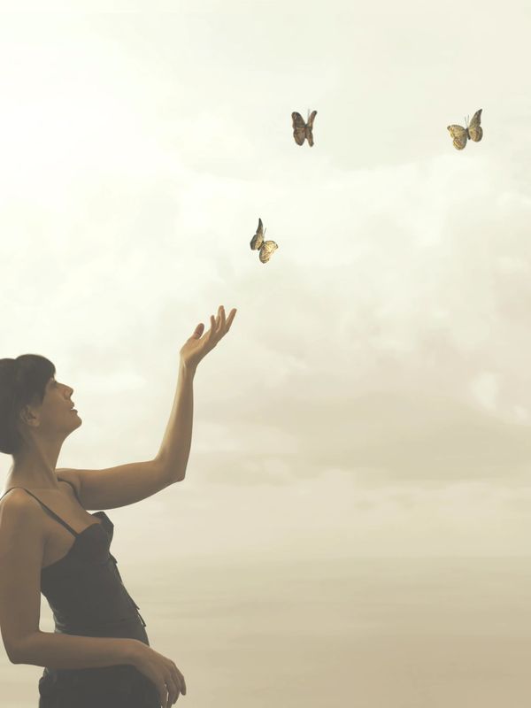 woman releasing butterflies