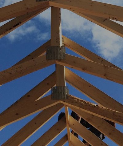 image of Ian Roberts from Roberts Carpentry working on framing project from below