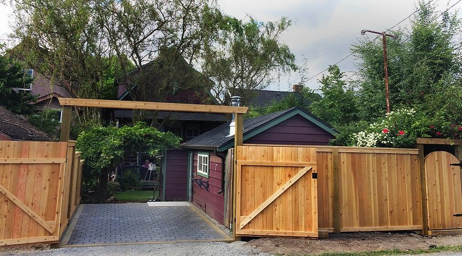 after image of the complete fence and gate project with the gate opened