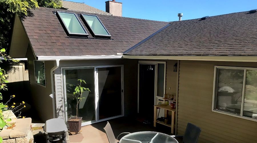 after image of new dining room renovation with skylights and sliding doors