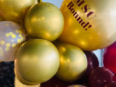 Gold and maroon balloons with "MSU Bound!" text and a gold star balloon.