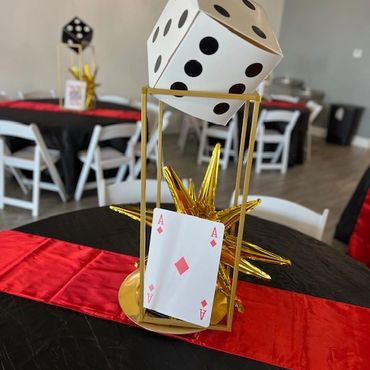 Table top poker decor centerpieces with table runner, gold charger, and card and dice deocr.
