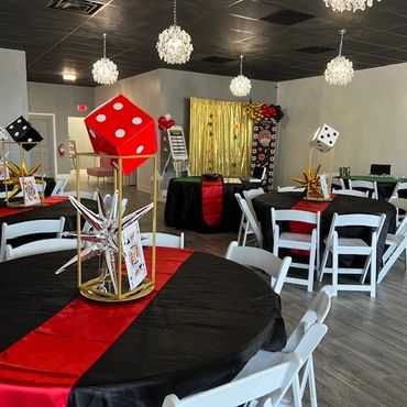 Casino themed party decor on tables and backdrop area.