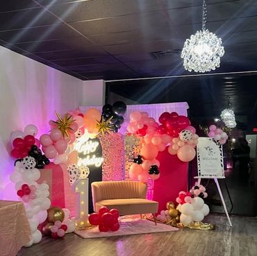 First birthday decor in pale pink, hot pink, and black.