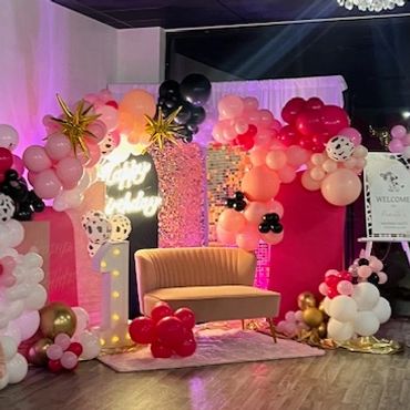 First birthday decor in pale pink, hot pink, and black.
