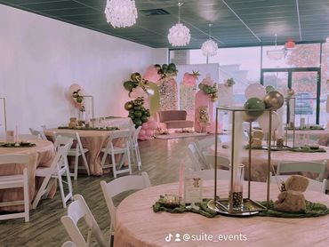 Overview of decorated venue for a baby girl shower in pink and green.