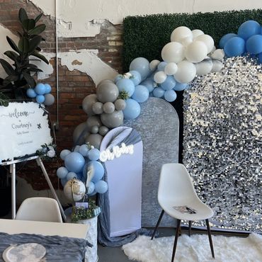 Baby shower theme "On Cloud Nine" showing arches and balloon garland with custom welcome sign.