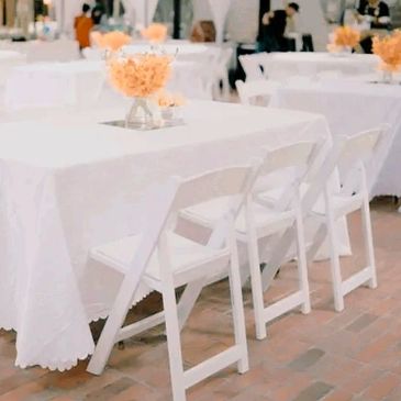 White banquet chairs that are provided by venue for your event.