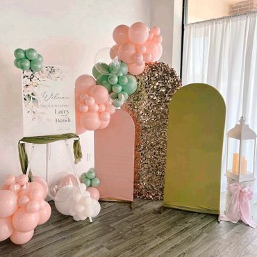 Elegant wedding welcome setup with balloons and decorative panels.