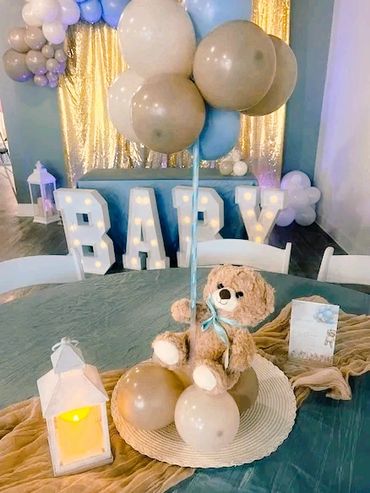 Custom table centerpieces for a baby shower to match their theme of "We Can Bearly Wait" in blue.
