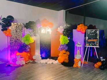 Halloween-themed party setup with colorful balloons and decorations.