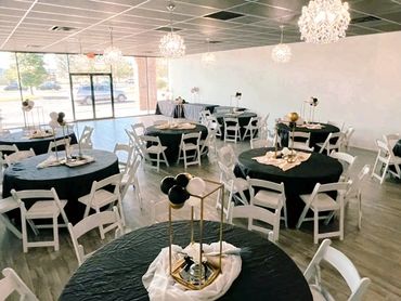 Venue plus decor in black, gold, and white for a graduation celebration.