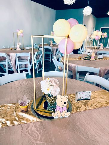 Winnie the Pooh Baby Shower centerpiece in pale pink, creamy yellow, and gold.
