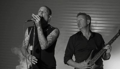 Black and white image of two musicians performing.