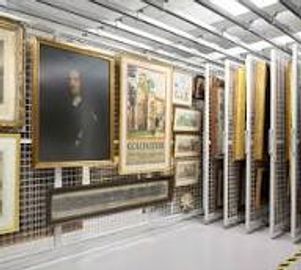 Artworks displayed on sliding panels in a well-lit gallery or storage area.
