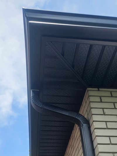 Seamless aluminum eavestrough installation on residential home exterior