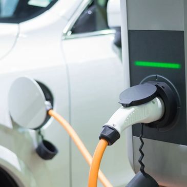 An electric vehicle charging at a post