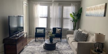 Cozy modern living room with neutral tones and elegant decor.