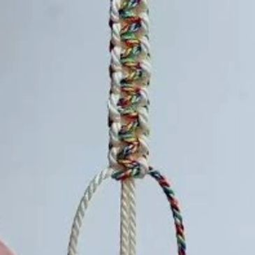 Colorful woven friendship bracelet in progress.