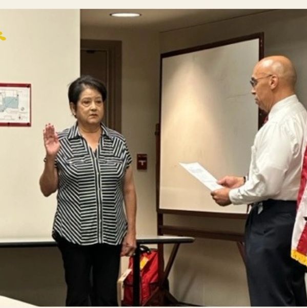 A woman taking an oath indoors.