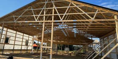 Barndominium post frame pole barn structure being built with metal siding and roofing