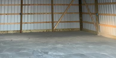 Post frame pole barn structure reinforced concrete floor with drainage poured and finished
