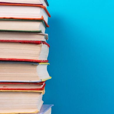 Stack of books with a blue background and L.L. Cummings in cursive at bottom.