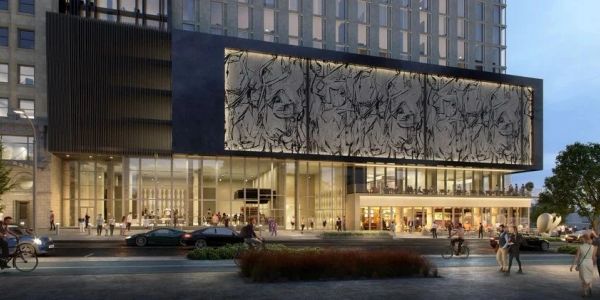 Modern building with large abstract art on facade.