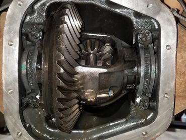 Close-up of an open vehicle differential showing gears and housing.