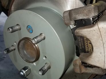 Close-up of a car brake rotor and caliper assembly.