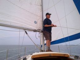 a man on the boat holding a stick