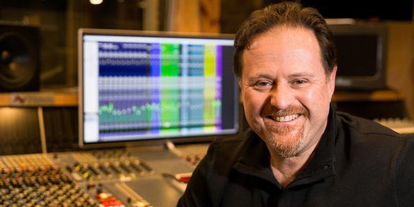 Smiling man in recording studio.