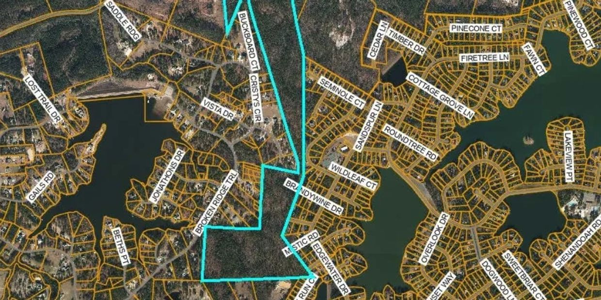 Aerial map showing property boundaries with street names and a highlighted land parcel.