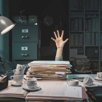 Desperate office worker overwhelmed with paperwork, she is asking help with her hand