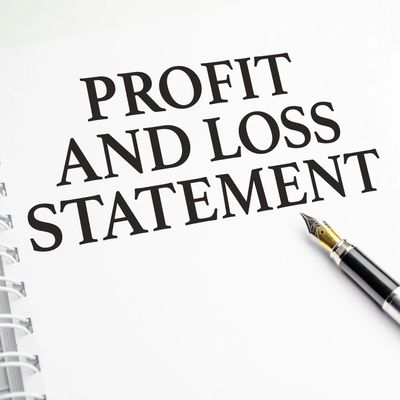 profit and loss statement words on white notebook