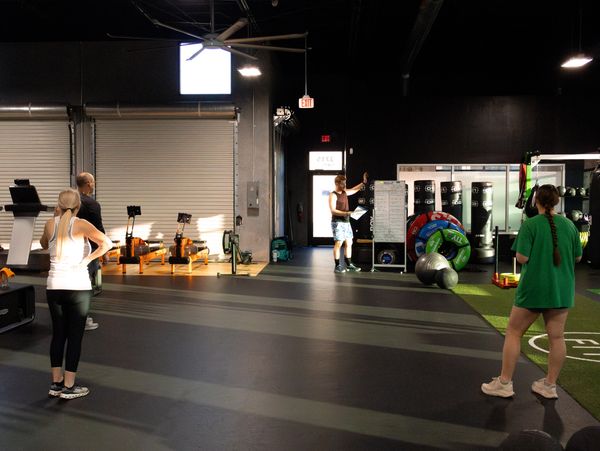 Personal trainer coaching proper lifting form in Lakeland FL