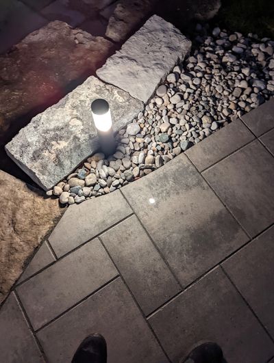a patio and stonework with outdoor lighting that was part of a full back yard design in Oakville