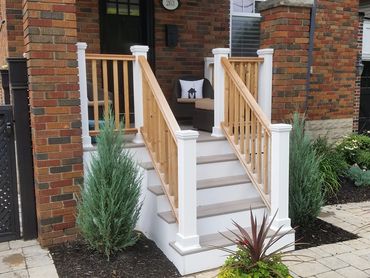 A custom composite and pvc deck in Milton, Ontario with custom cedar railings by deck contractor