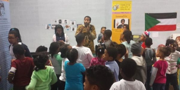 Dr. Ayize with the children at the Children's Interactive History workshop