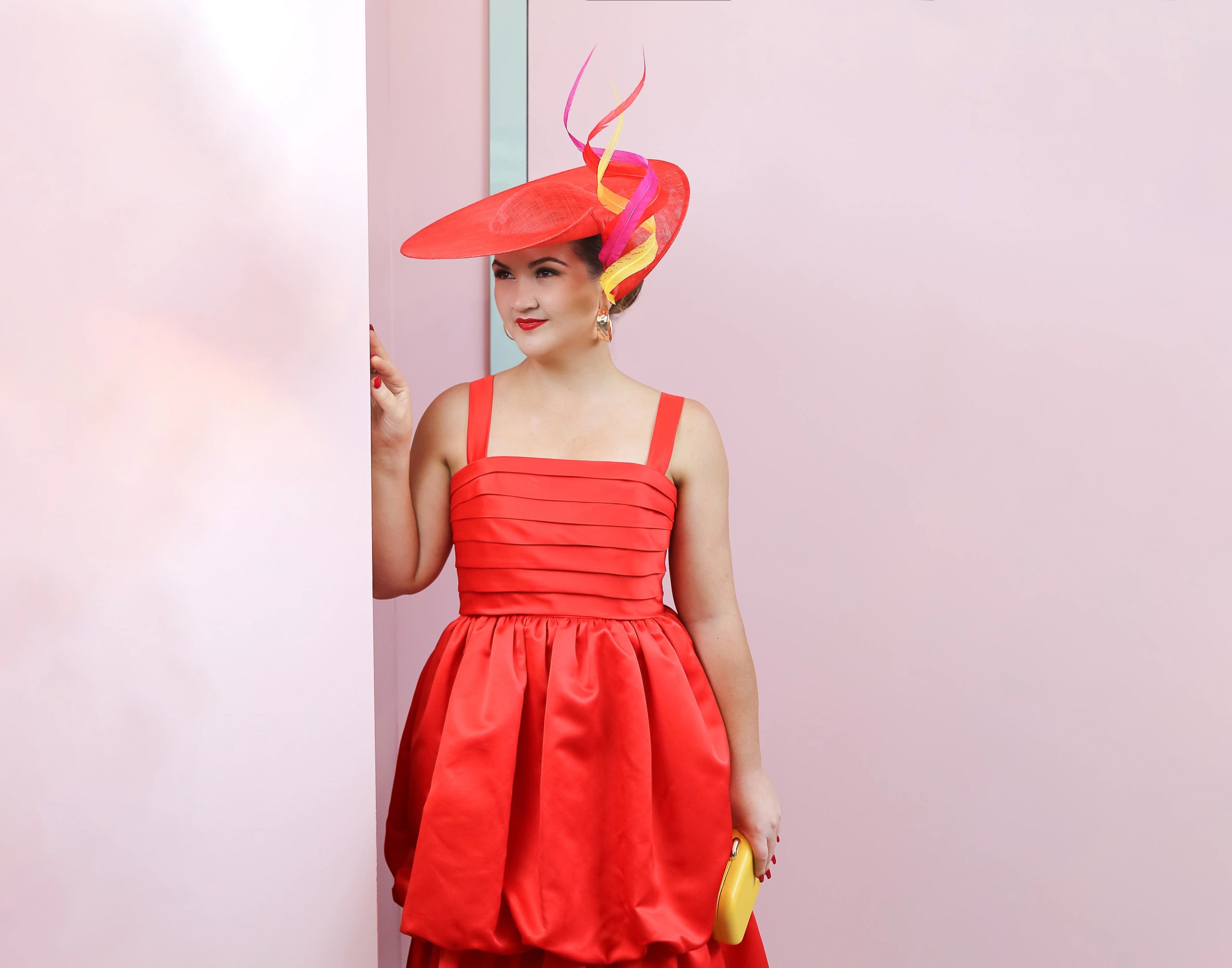 Peacock Millinery client wearing her self-styled outfit with custom couture hat.