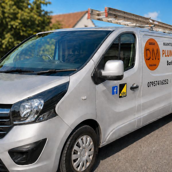 Silver plumbing and heating service van with ladder on top.