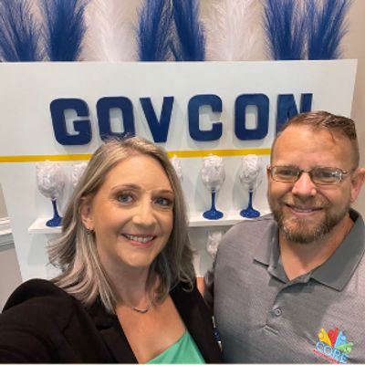 CEO and CEO smiling in a picture at a GOVCON event.