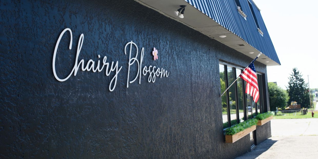 Exterior of Chairy Blossom building with American flag.