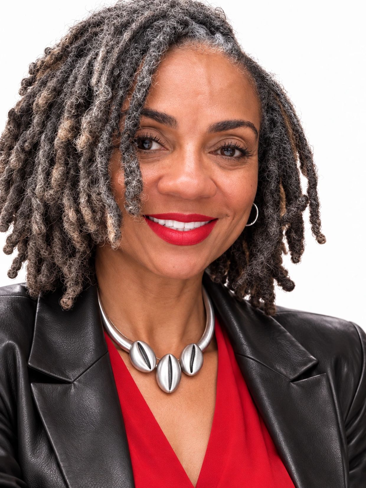 Smiling woman with curly gray hair and red lipstick.